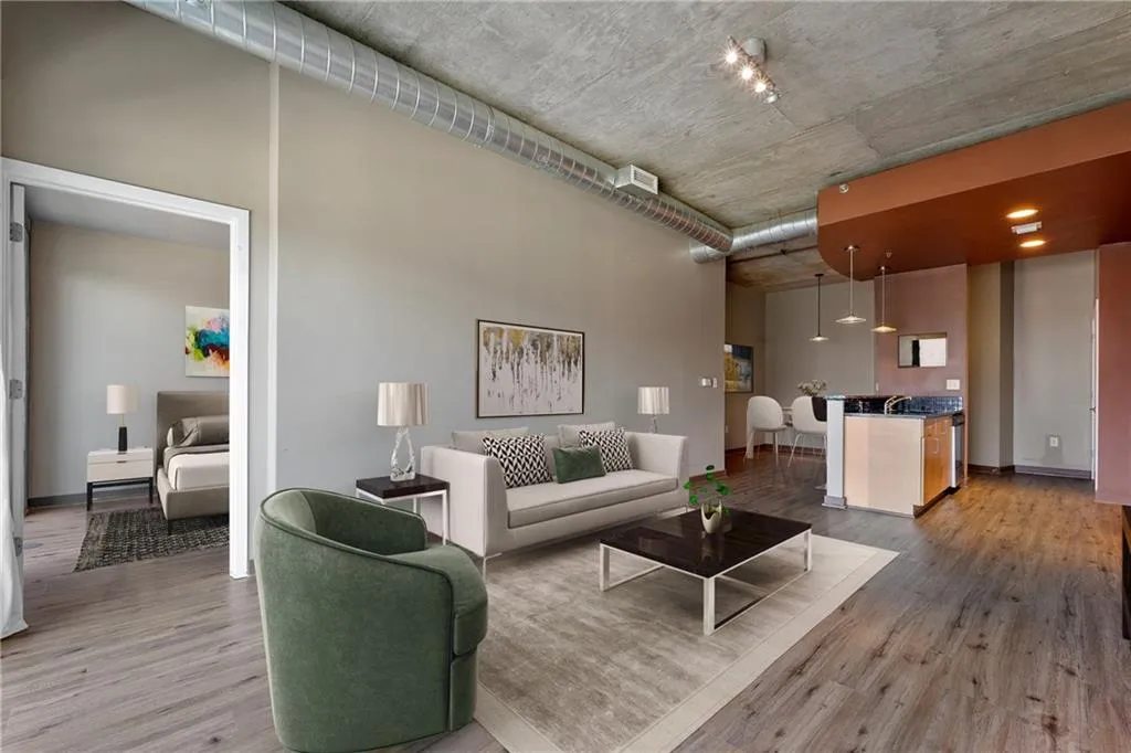 Living room featuring wood finished floors and a towering ceiling