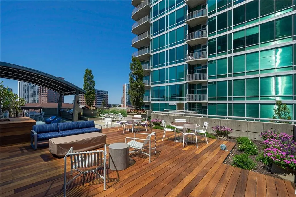 Wooden deck with outdoor dining space and a view of city