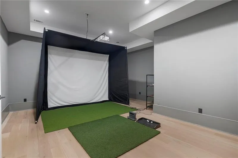 Dedicated indoor golf simulator with projector and screen