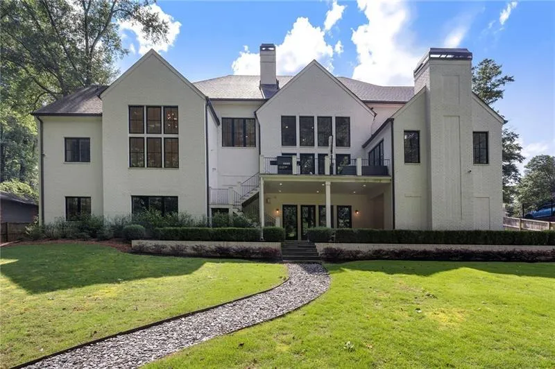 Elegant white brick exterior featuring black-framed windows and a multi-level design