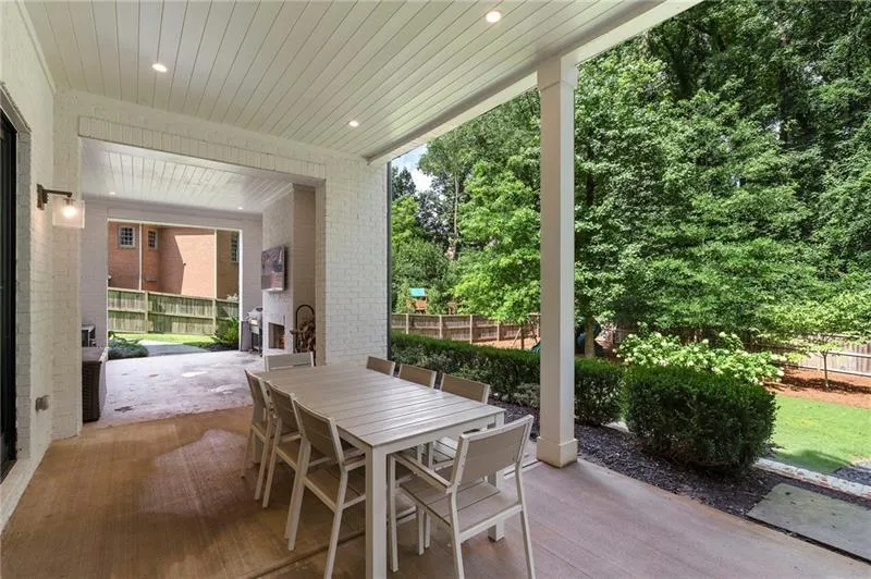 Covered outdoor living space featuring a wood-panel ceiling with recessed lighting