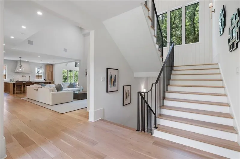Staircase with black metal balusters and wood-finish treads