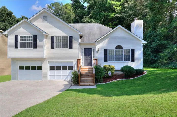 Siding exterior with multiple gables, a covered entry, and a two-car garage