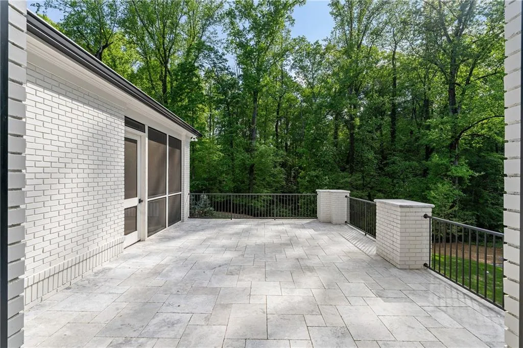 Sun drenched patio off screened porch and main level bedroom.  Perfect for a guest suite.