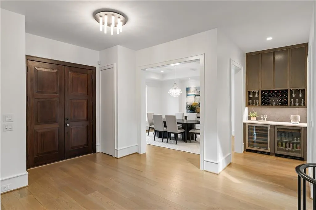 Two closets with discreet doors flank the entryway