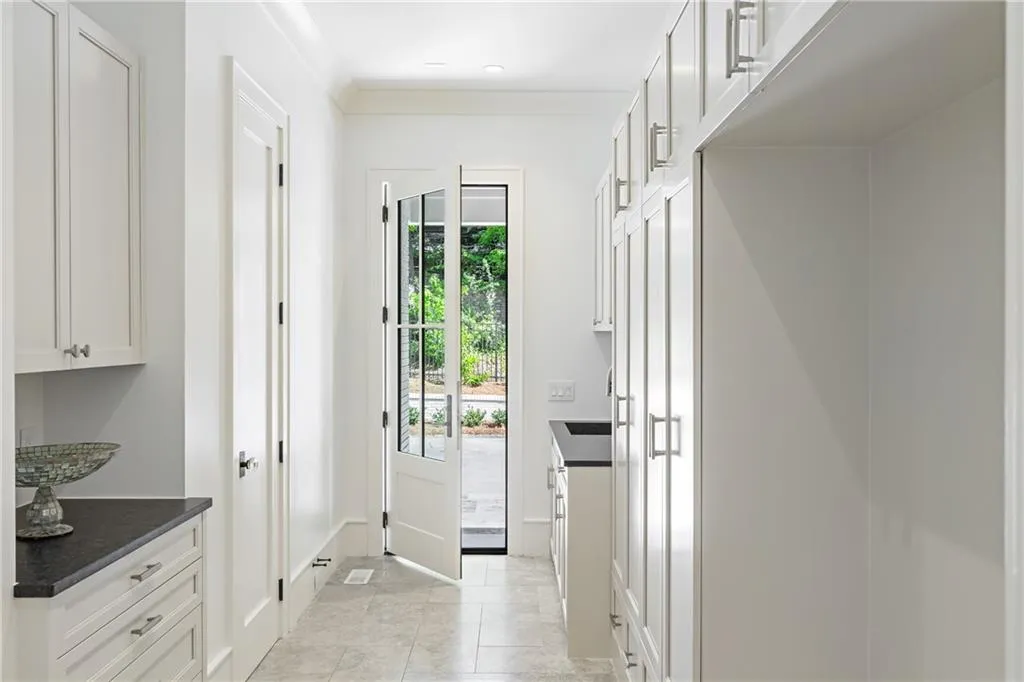 Mudroom off three car stepless entry garage and driveway. Custom storage lockers and cabinets.