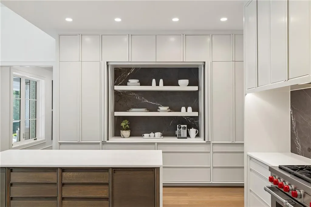 Gorgeous marble backsplash in custom hidden pantry.