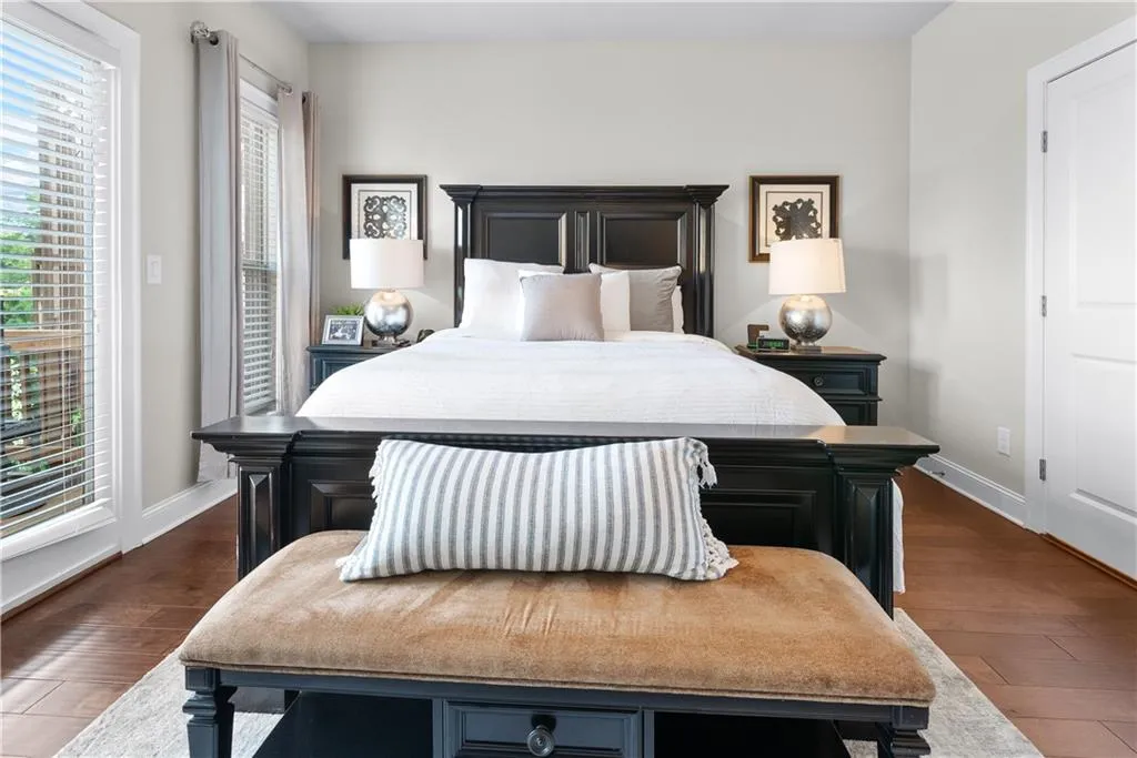 Bedroom with dark hardwood / wood-style flooring and wood walls