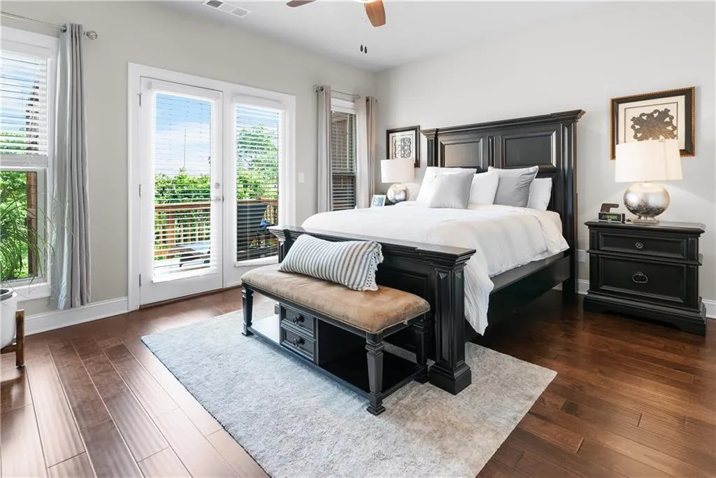 Bedroom with dark hardwood / wood-style flooring