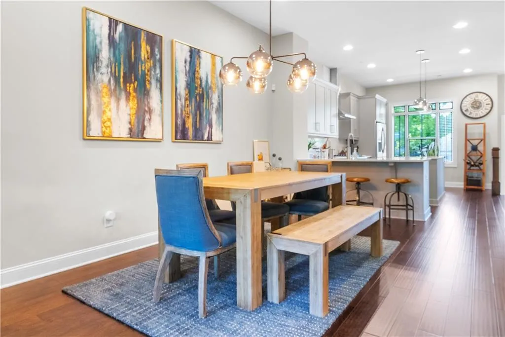 Living room with light hardwood / wood-style flooring, brick wall, and ceiling fan