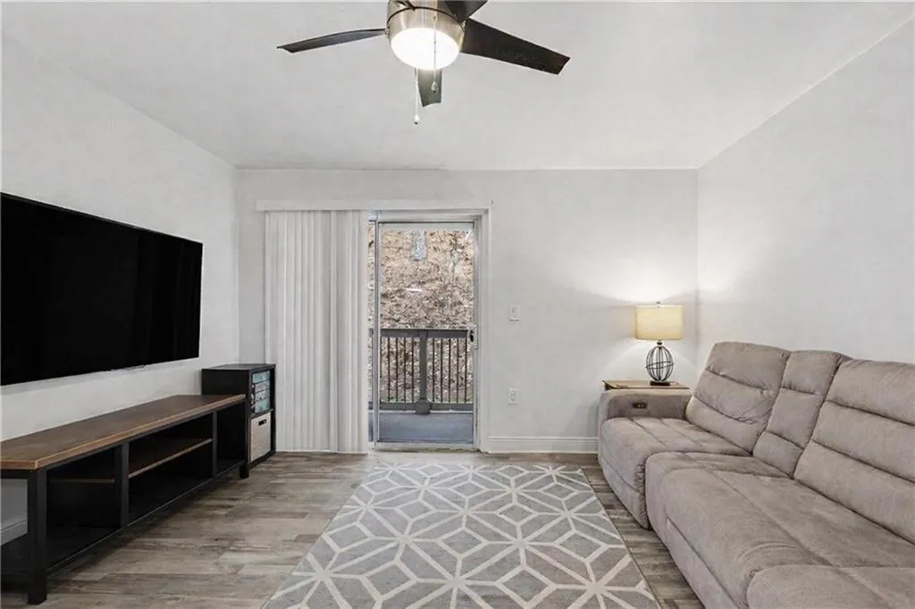 Living area featuring light wood finished floors and a ceiling fan