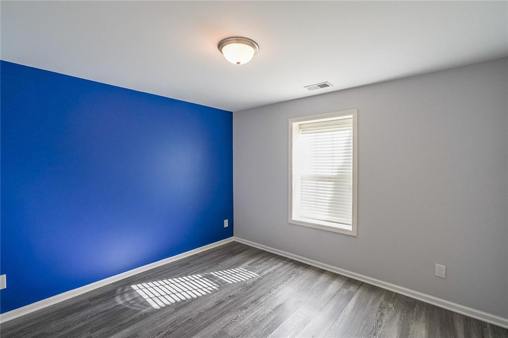 Empty room with dark wood-type flooring