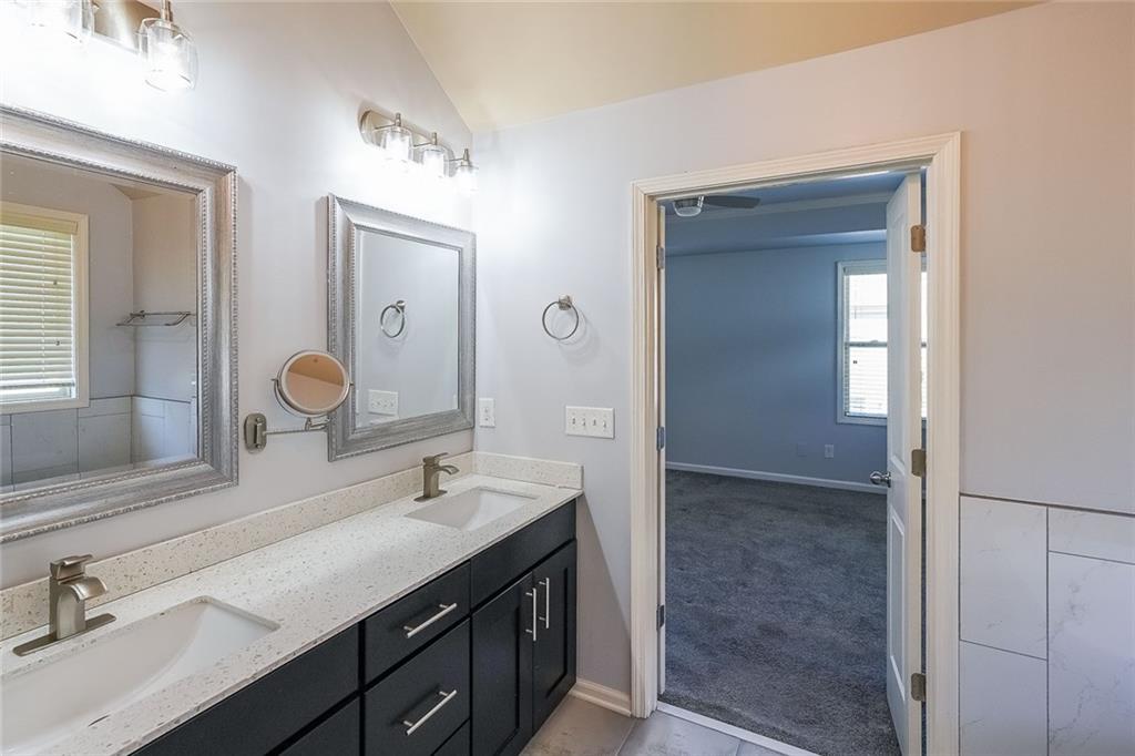 Bathroom with double vanity and vaulted ceiling