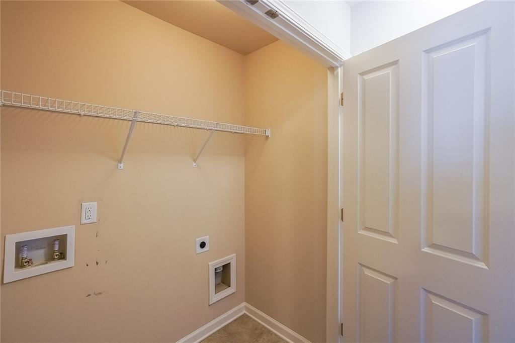 Washroom with light carpet, electric dryer hookup, and washer hookup