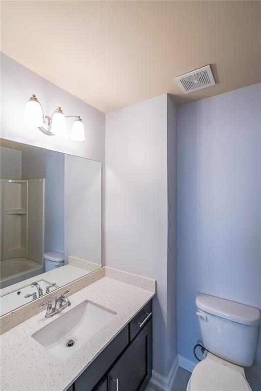 Full bathroom with bathing tub / shower combination, toilet, and oversized vanity