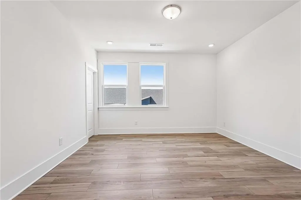 Spacious Primary Bedroom with Plank Flooring