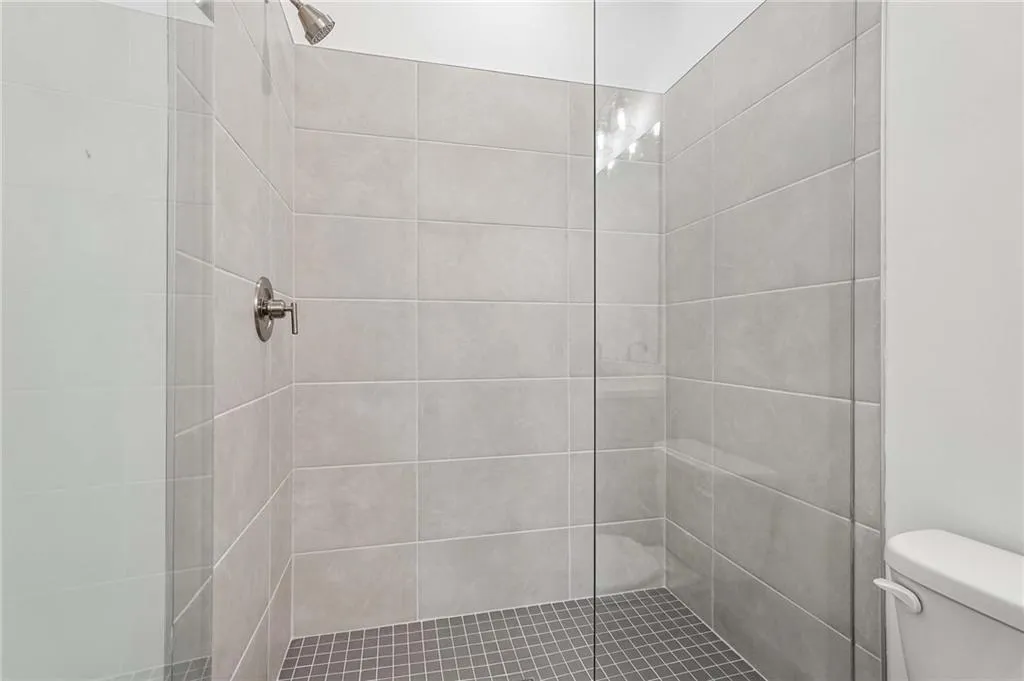 Spa-like with Double Vanity Sinks, Tile Shower with Frameless Doors, and Tile Flooring