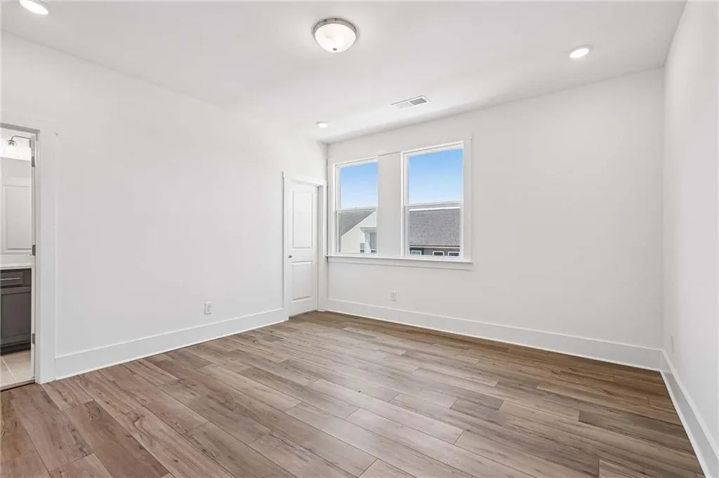 Spacious Primary Bedroom with Plank Flooring