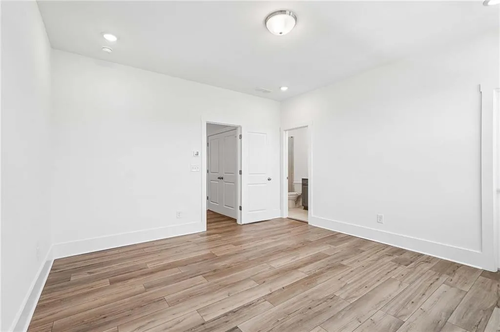 Spacious Primary Bedroom with Plank Flooring