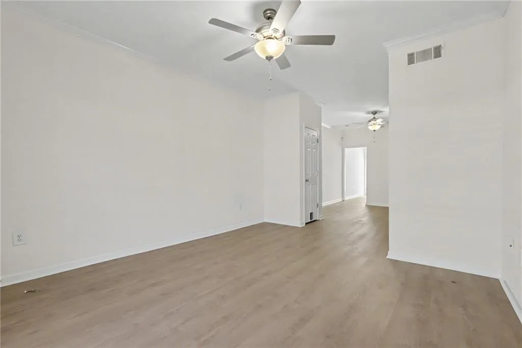 Wood-finish flooring, crown molding, and ceiling fans