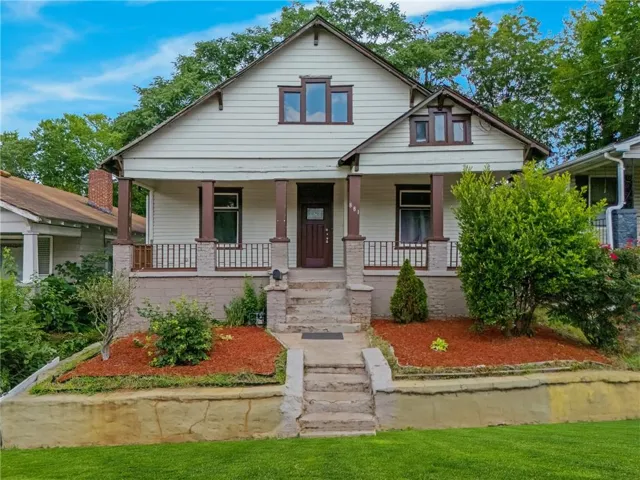 Craft-style residence featuring a prominent covered front porch with stone and wood pillars