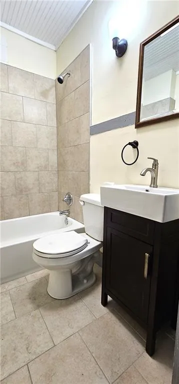 Full bath with toilet, vanity, washtub / shower combination, and tile patterned flooring