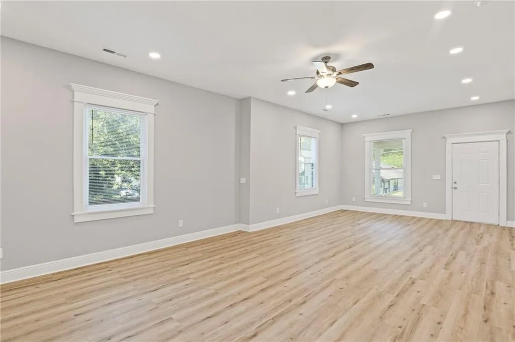 Empty room featuring a ceiling fan, light wood-style flooring, and recessed lighting