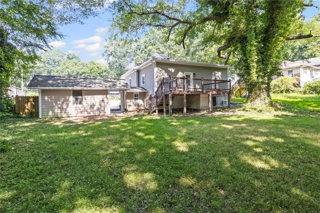 Rear view of property with stairway and a deck