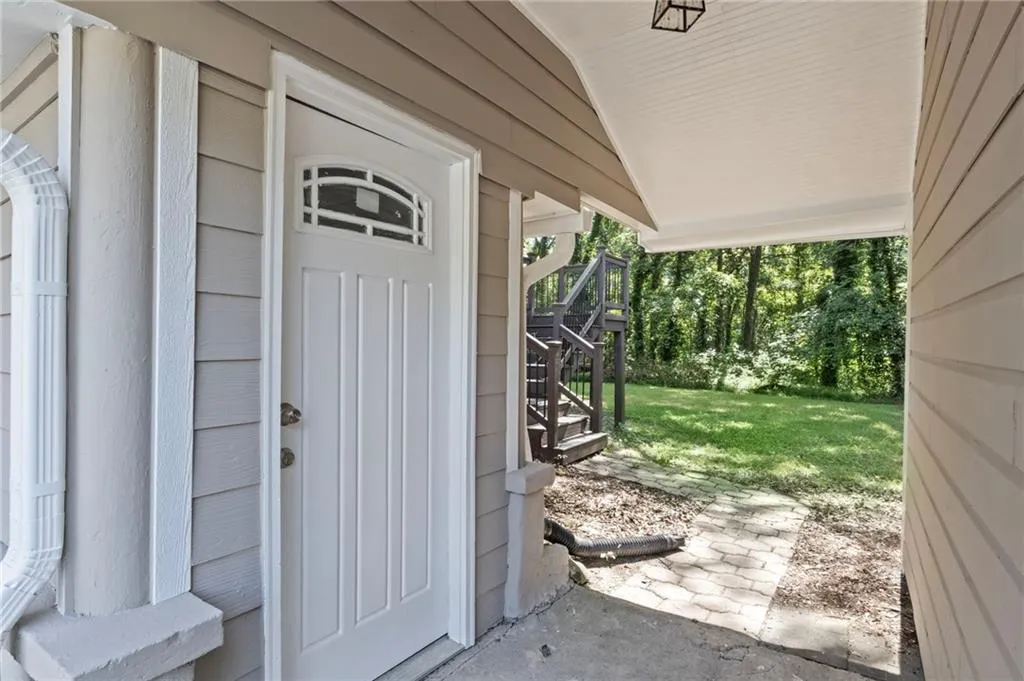 Doorway to property featuring a lawn