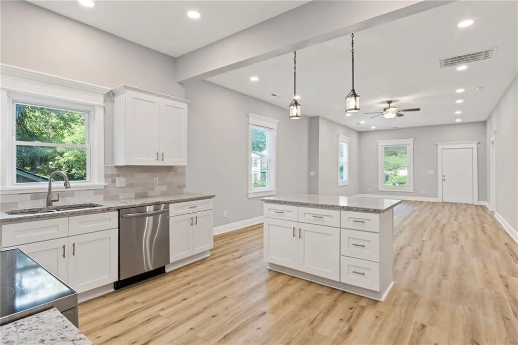 Kitchen with dishwasher, light wood-style floors, electric stove, ceiling fan, and recessed lighting