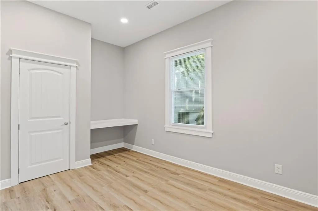 Unfurnished room featuring wood finished floors and recessed lighting