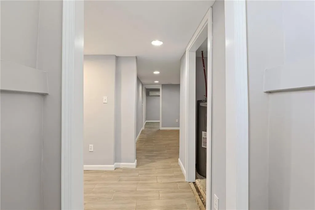 Hallway featuring light wood-style flooring and recessed lighting
