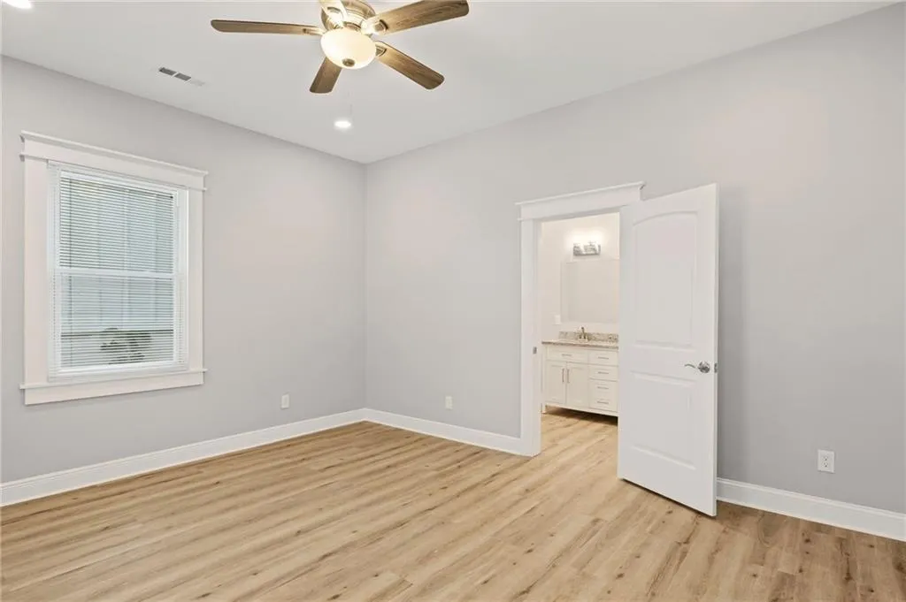 Spare room featuring light wood finished floors, ceiling fan, and recessed lighting