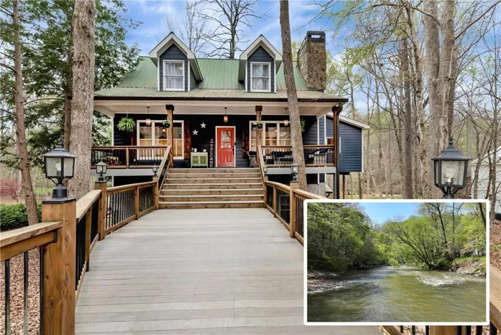 View of front of home with a water view, a metal roof, a chimney, and covered porch