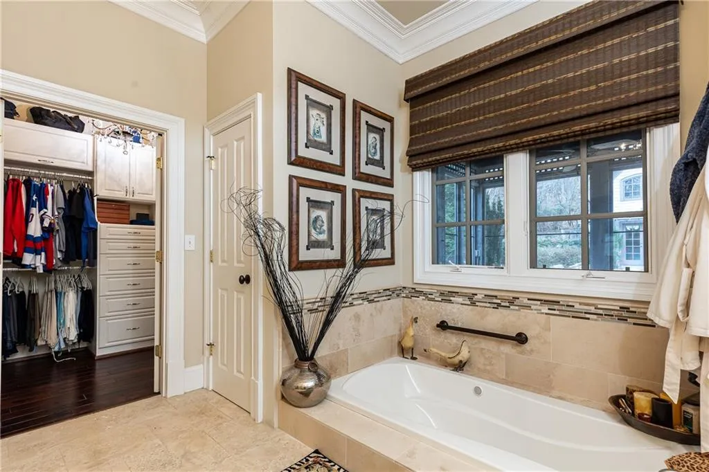 See sunken soaking tub and one of two Walk-In Custom Closets.