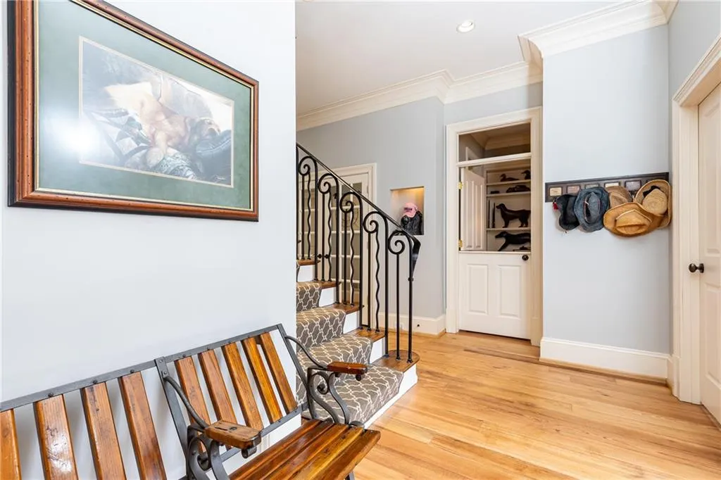 Hallway open from secondary front entry. Staircase to upper level.