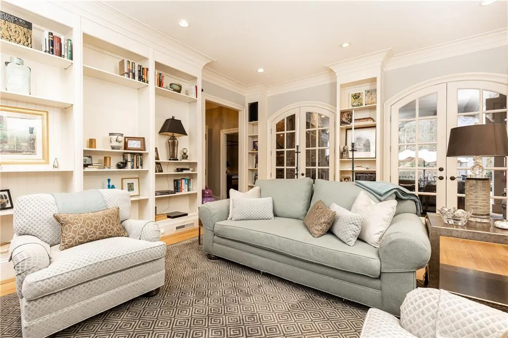 Living Room/Study accesses back Patio through two sets of arched French doors.