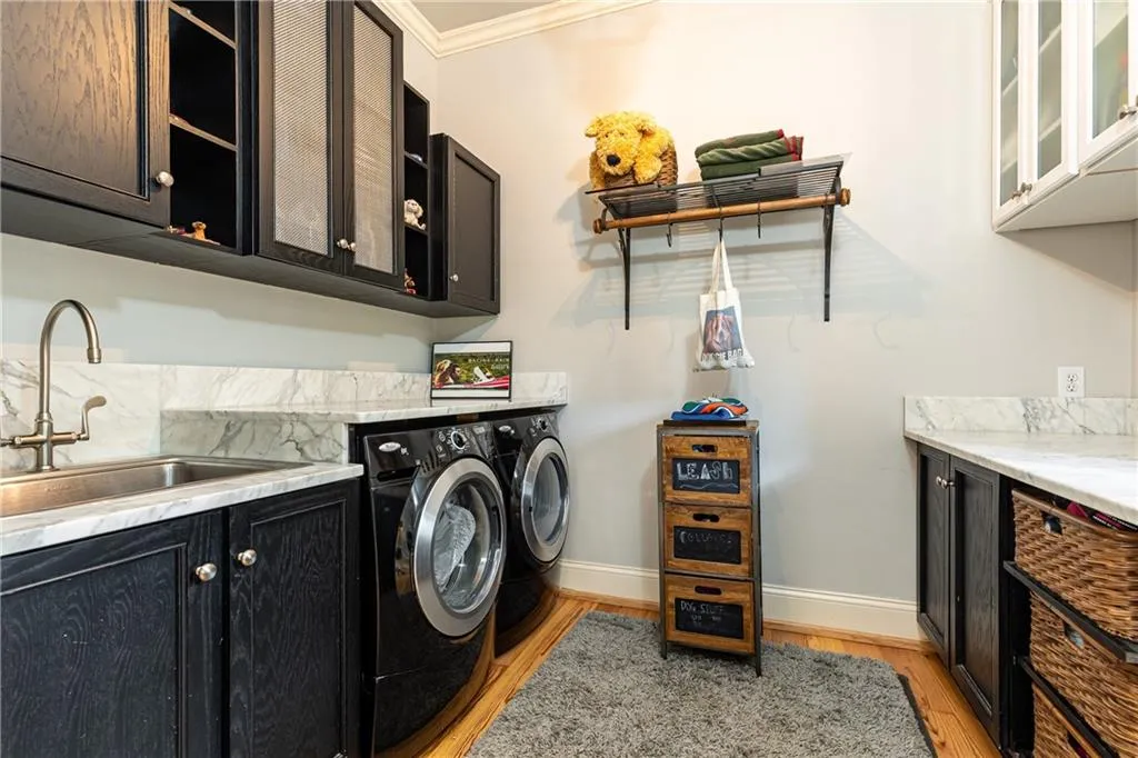 Laundry Room with plenty of storage, utility sink and folding counter.