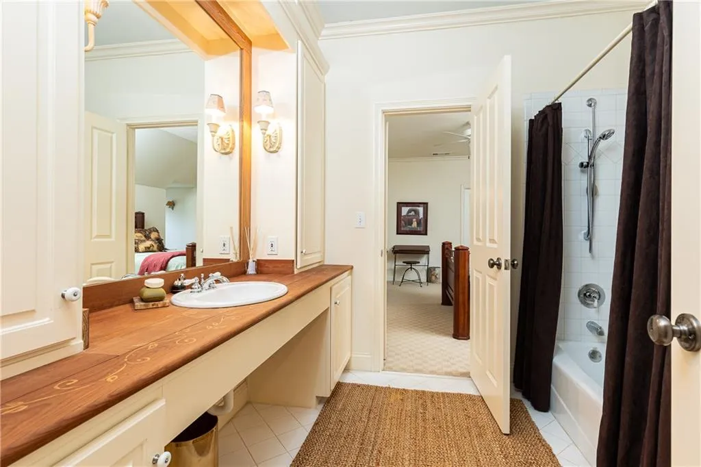 Secondary Bathroom with tub/shower combination serves bedroom and game/exercise room.