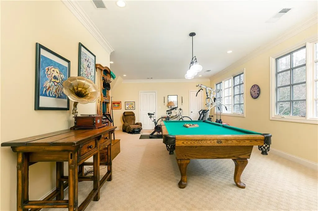 Currently used as a combination recreation/game/exercise room. Room could serve as an additional large bedroom and has a walk-in cedar closet, two other storage closets, plus opens to unfinished attic space providing additional storage.