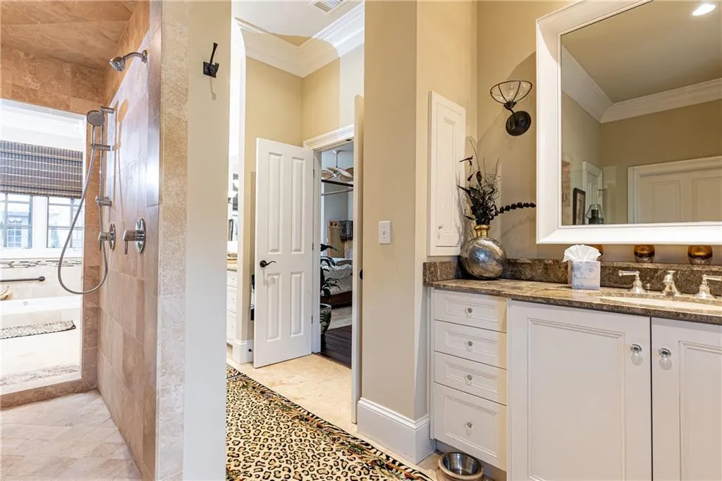 There are two single-sink, stone-topped vanities and two private water closets.