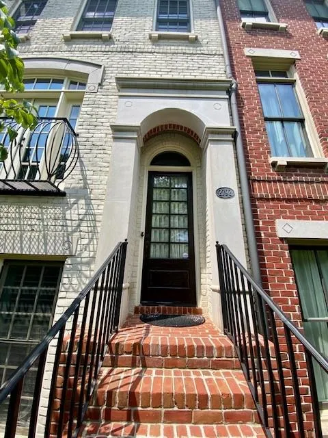 Doorway to property featuring brick siding