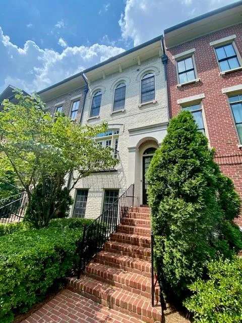 View of front of home with brick siding and stairway
