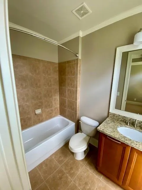 Full bathroom with vanity, bathtub / shower combination, light tile patterned floors, and ornamental molding