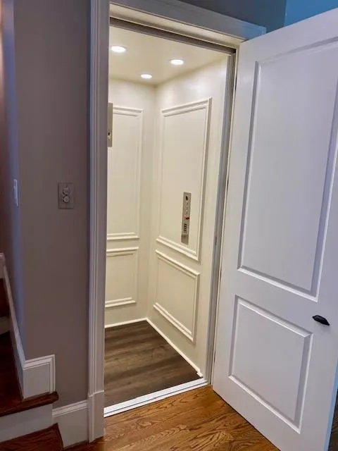 Elevator with wood finished floors and recessed lighting