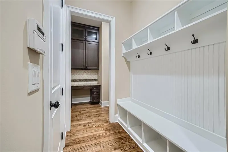 Mudroom with light wood finished floors and baseboards