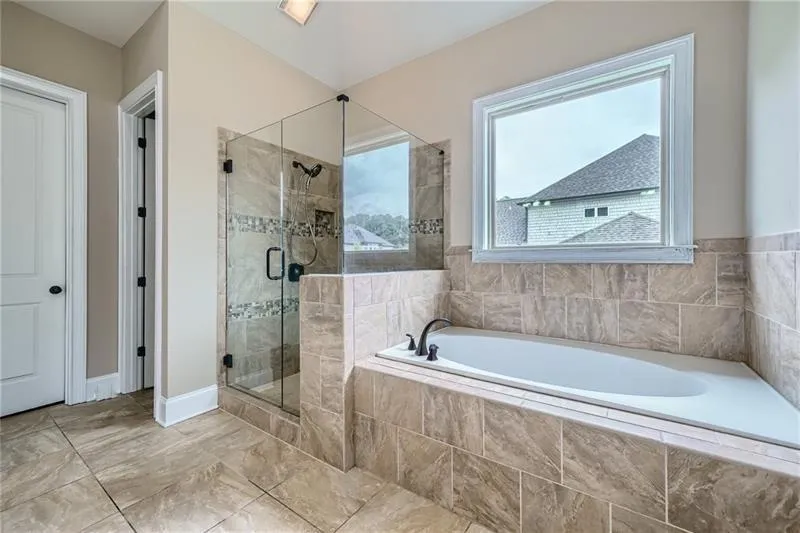 Bathroom with a stall shower and a garden tub