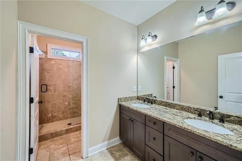 Bathroom with a stall shower and light tile patterned flooring