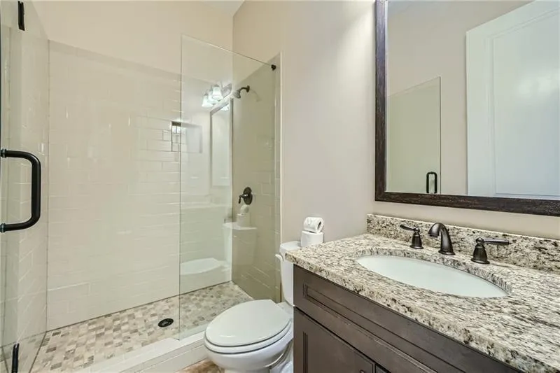 Bathroom featuring a shower stall and vanity