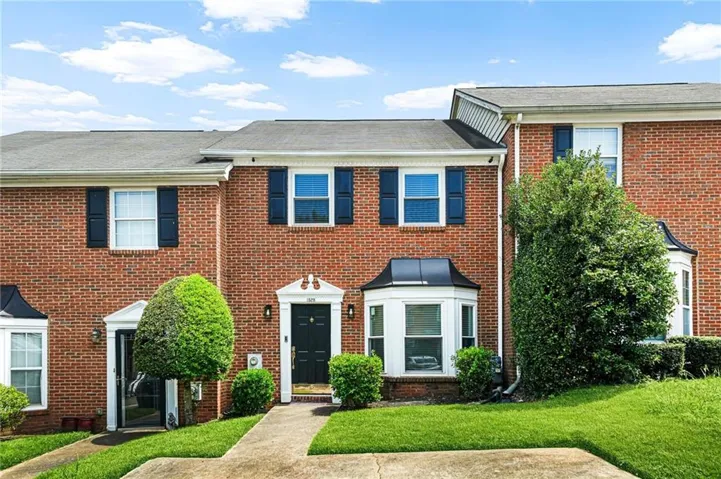 Brick exterior with black shutters and white trim